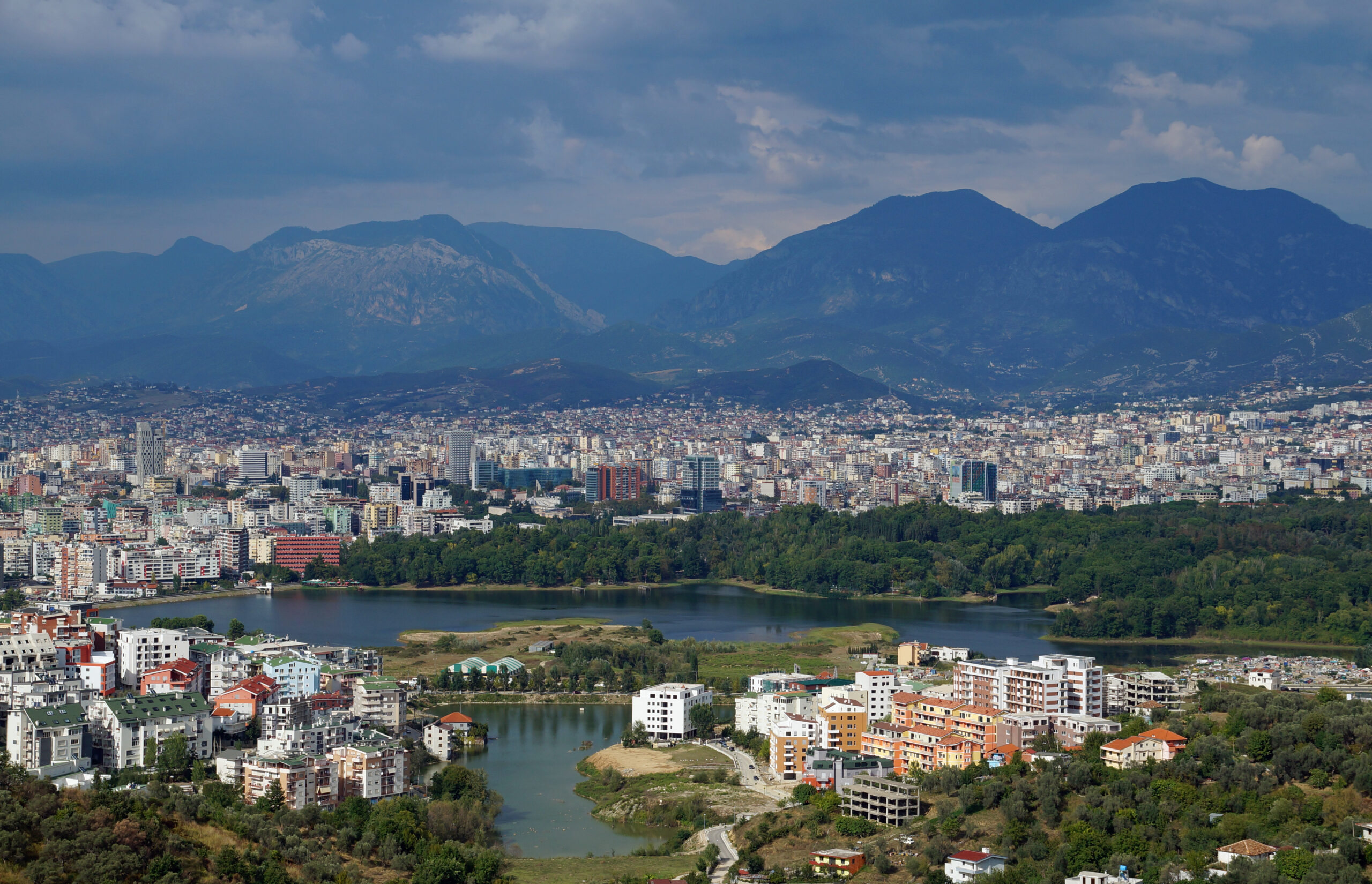 Beautiful Tirana cityscape with a mix of colorful buildings and mountains in the background